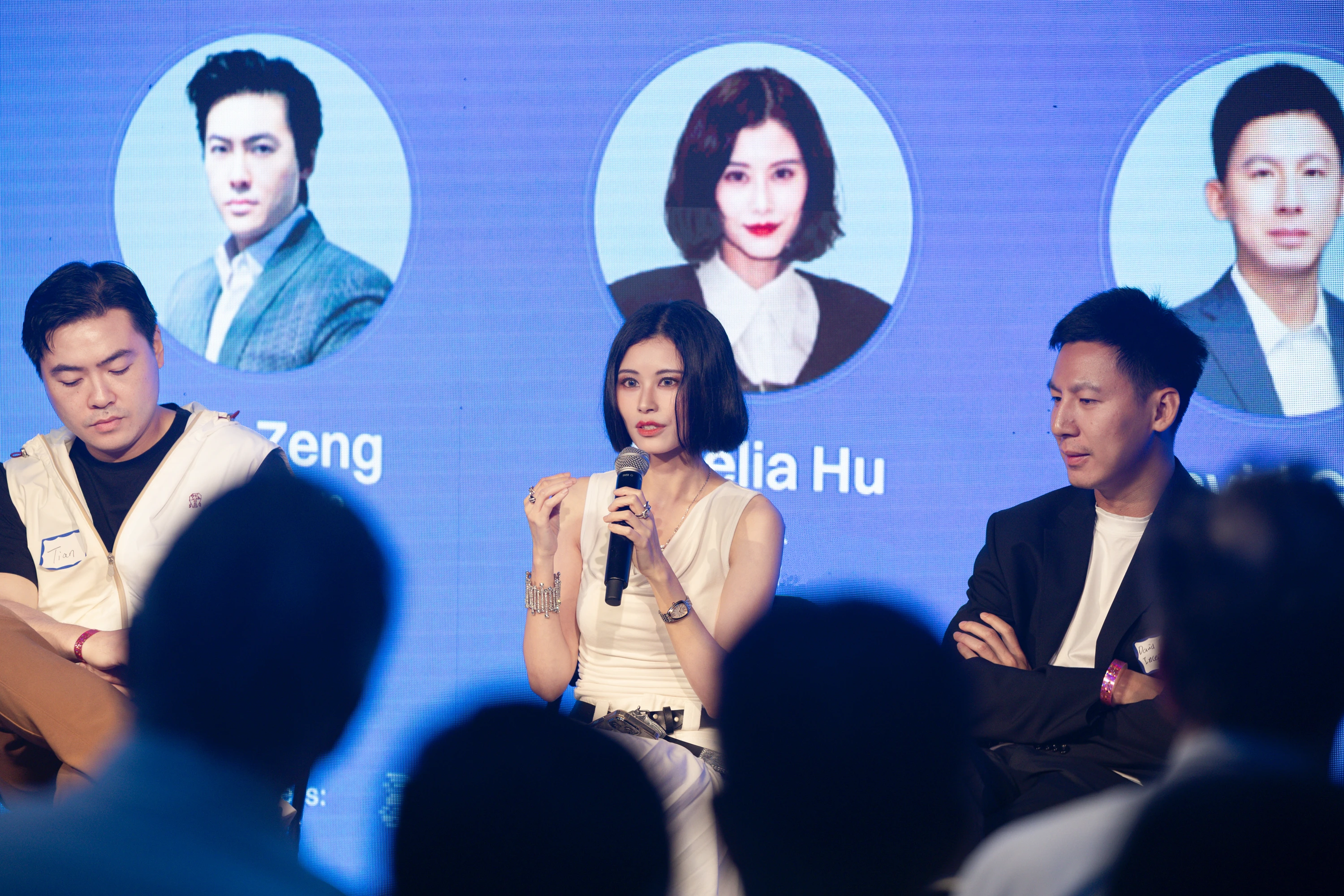Amelia Hu speaking into a microphone during a panel at ETH Week 2025